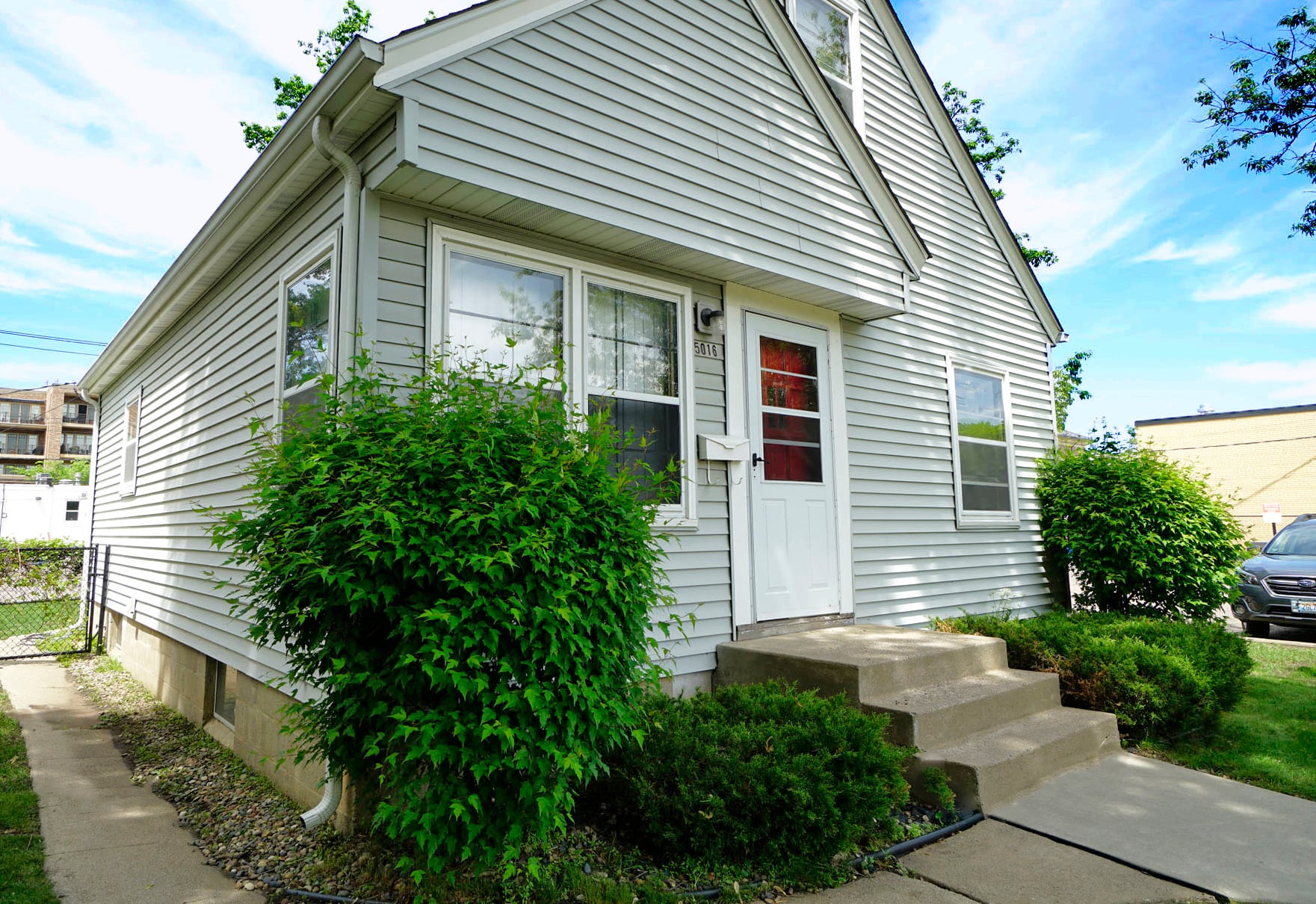 A house with a red door and a white front door.
