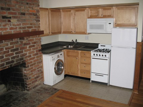 a kitchen with a stove refrigerator and a washing machine