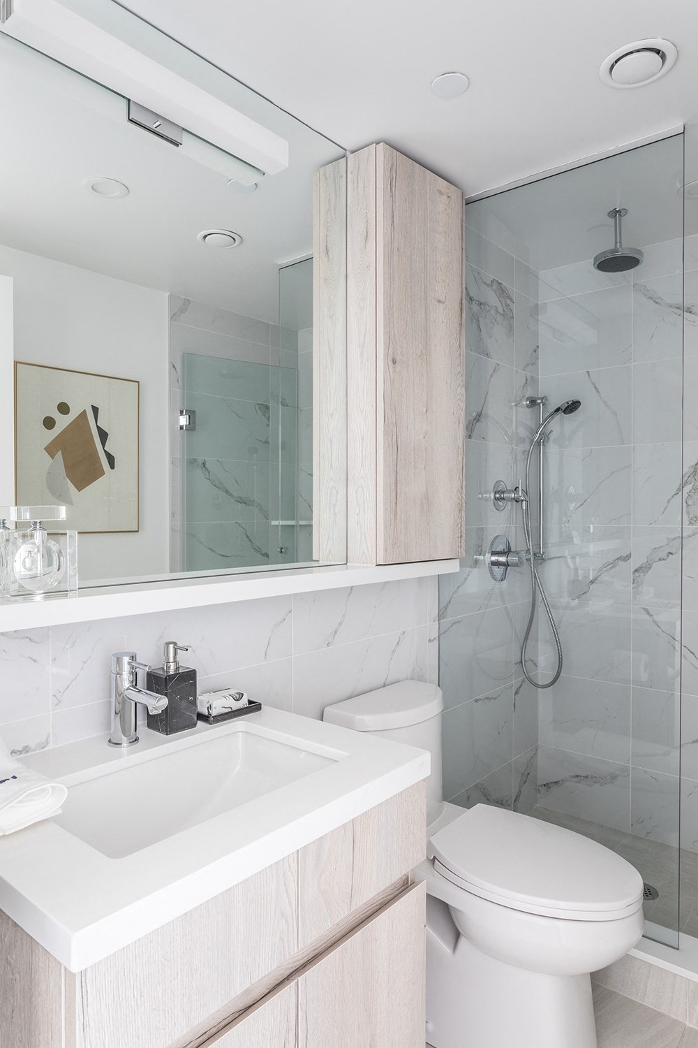 a bathroom with a toilet and a sink and a shower