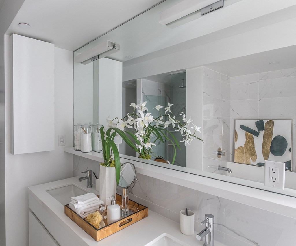a white bathroom with a sink and a mirror