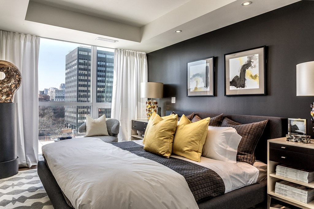 a bedroom with a bed and a view of the city