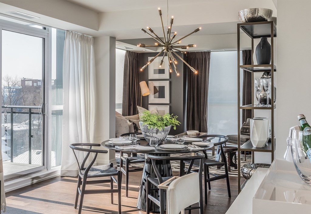 a dining room with a table and chairs and a chandelier
