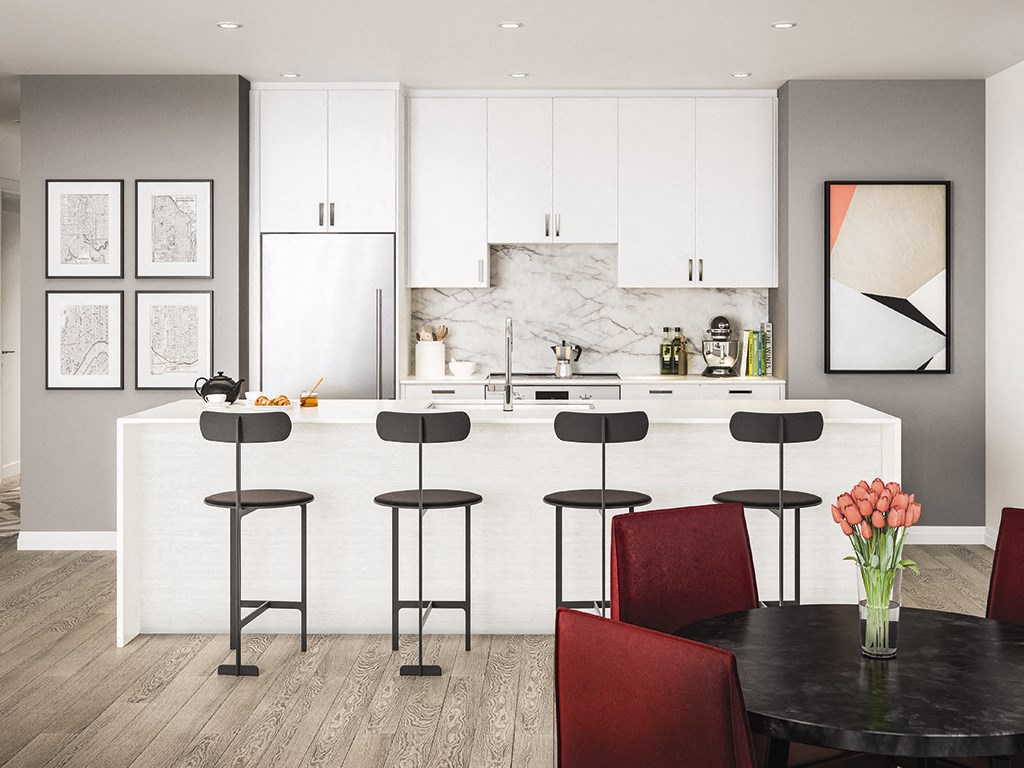 a kitchen and dining room with white cabinets and a table with chairs