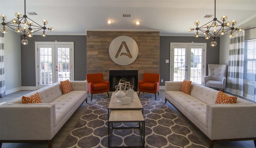 a living room with couches and chairs and a fireplace