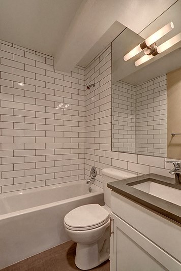 a white bathroom with a toilet and a sink