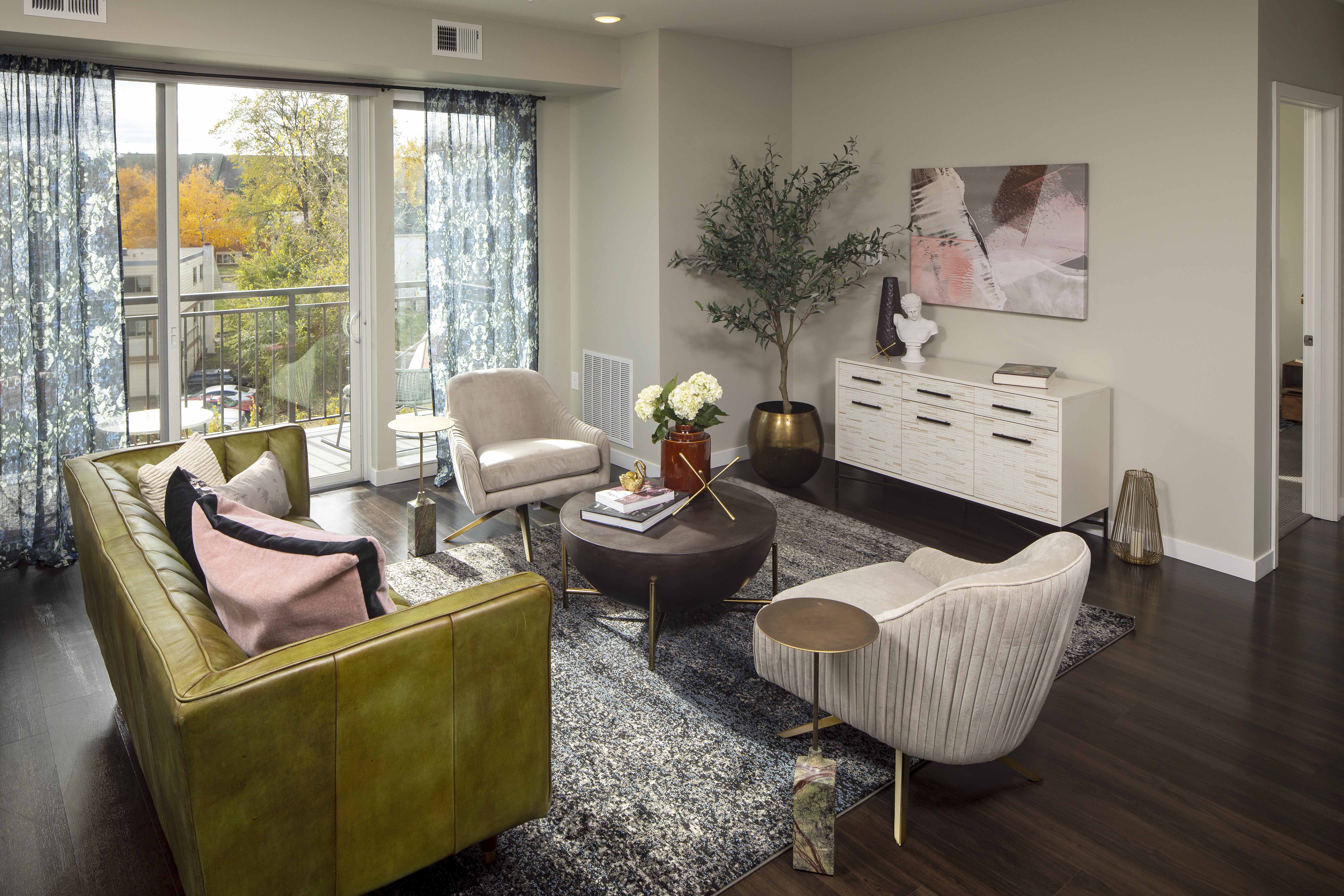 a living room with a couch chairs and a table