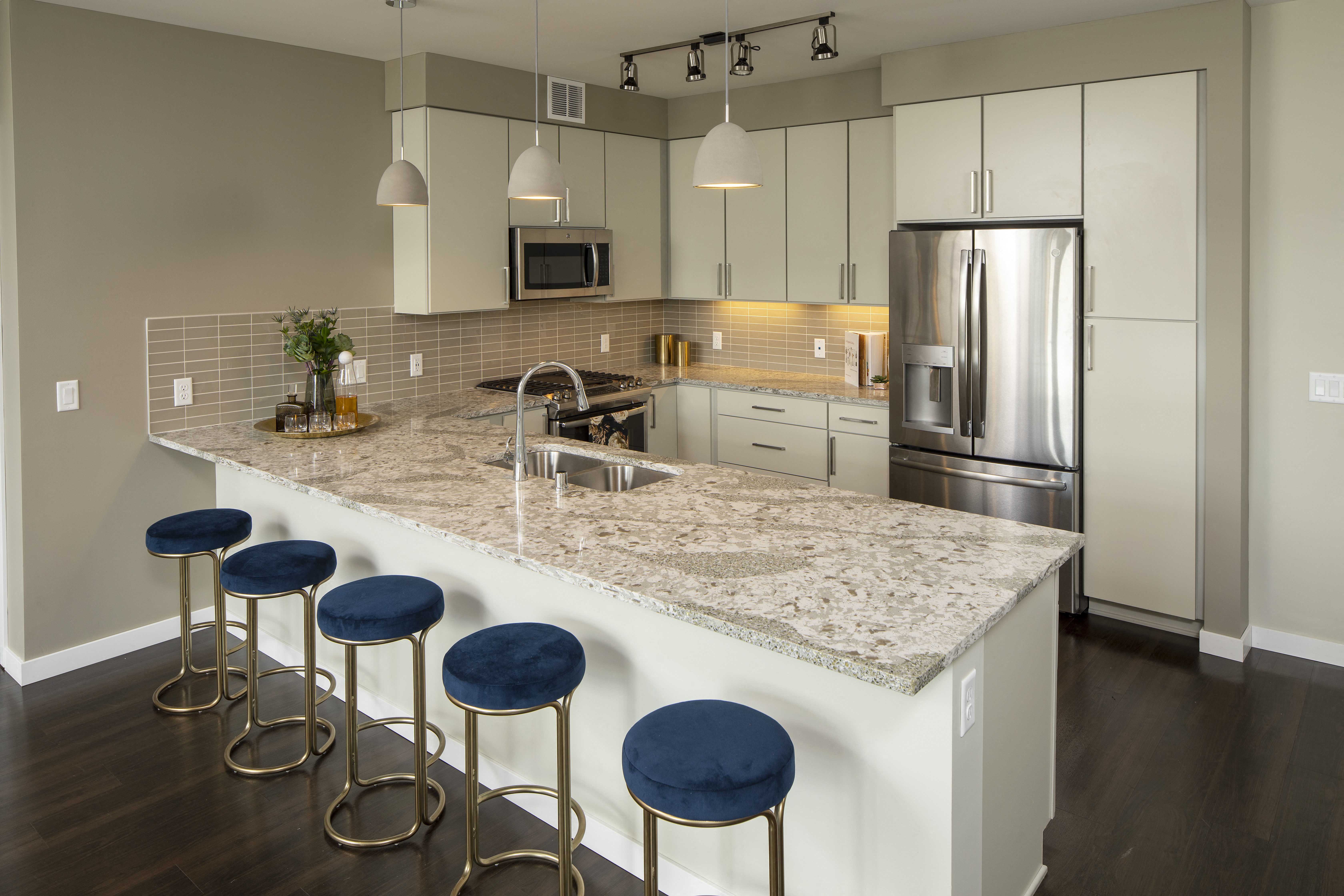 a kitchen with a marble counter top and stainless steel appliances
