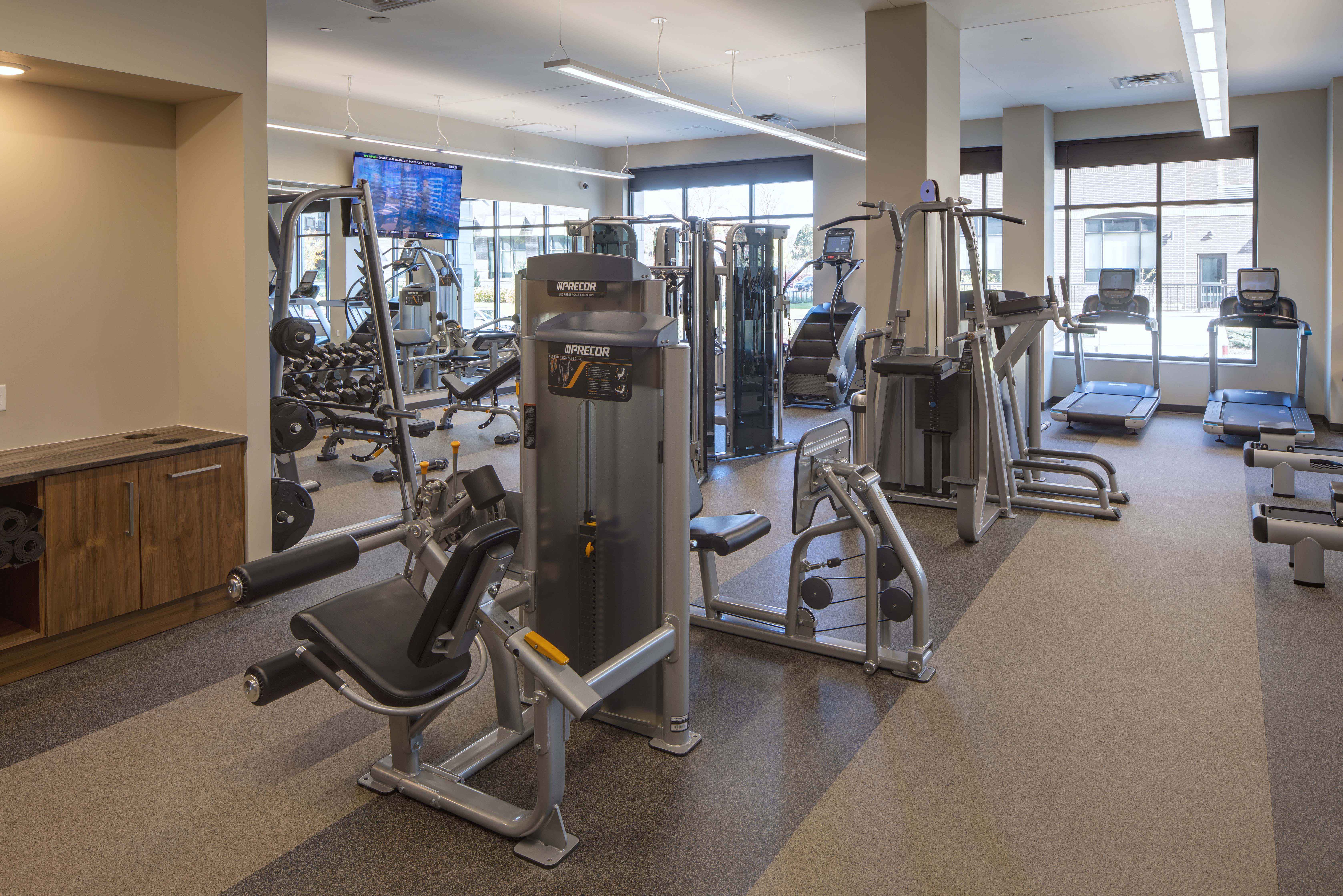 a gym with weights and other exercise equipment in a building