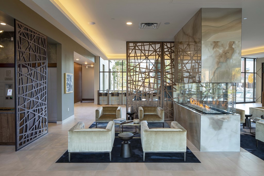 the lobby of a hotel with a reception desk and couches