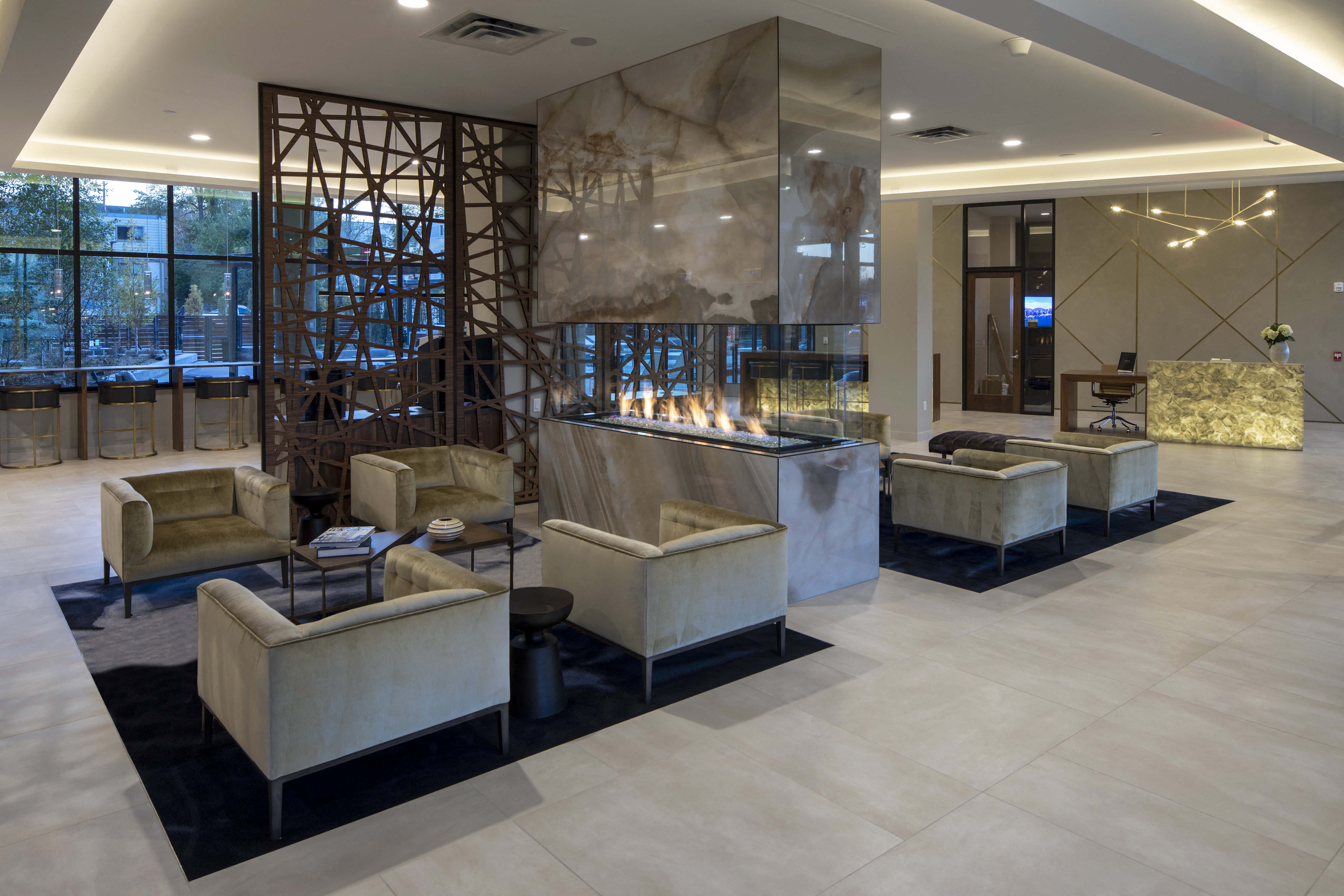 the lobby of a hotel with couches and a reception desk