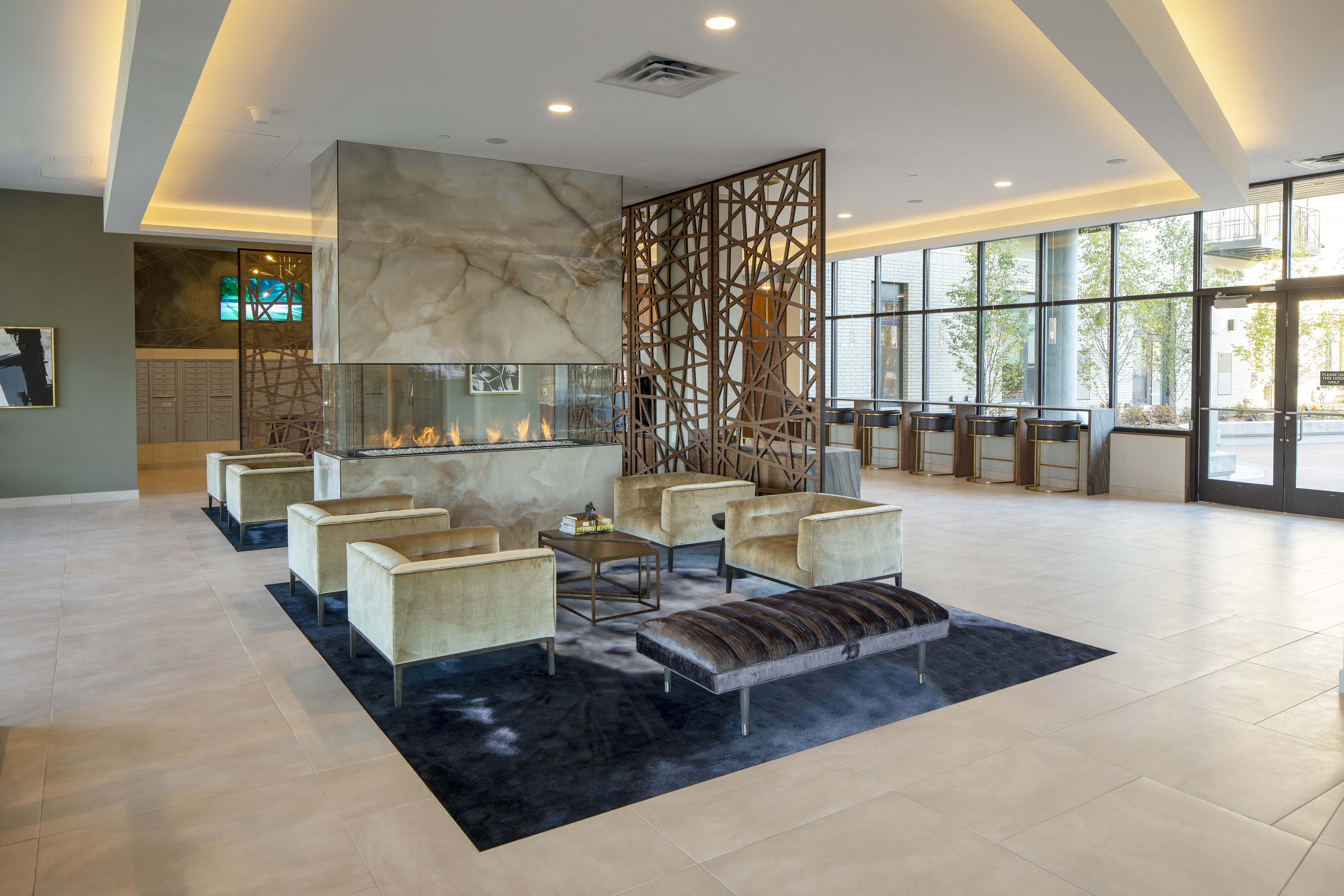 a lobby with a seating area and a fireplace