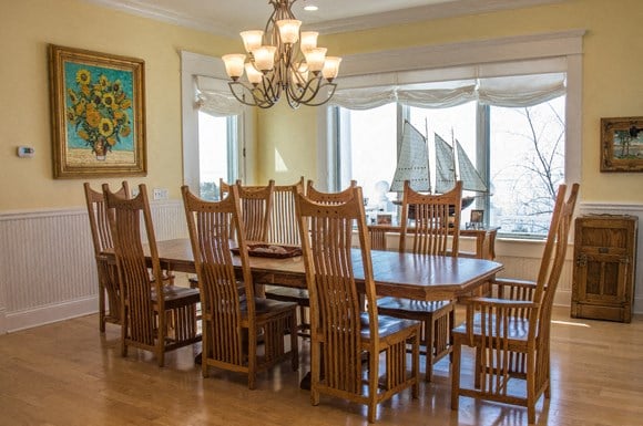 a dining room with a wooden table and chairs