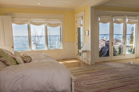 a bedroom with a bed and a view of the ocean