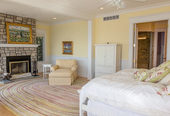 a bedroom with a bed and a fireplace