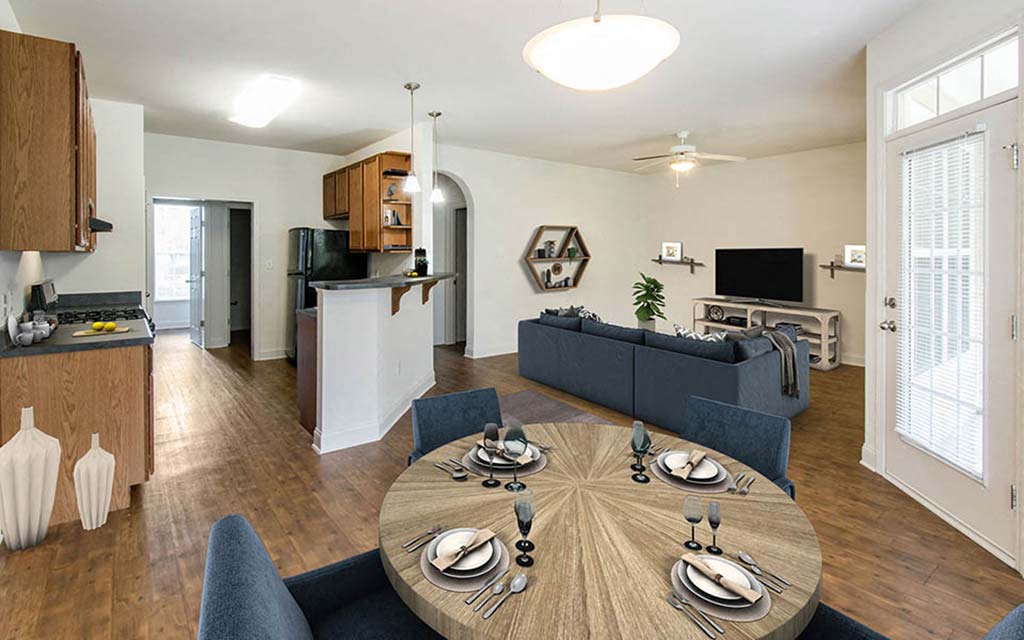 a living room and kitchen with a table and chairs