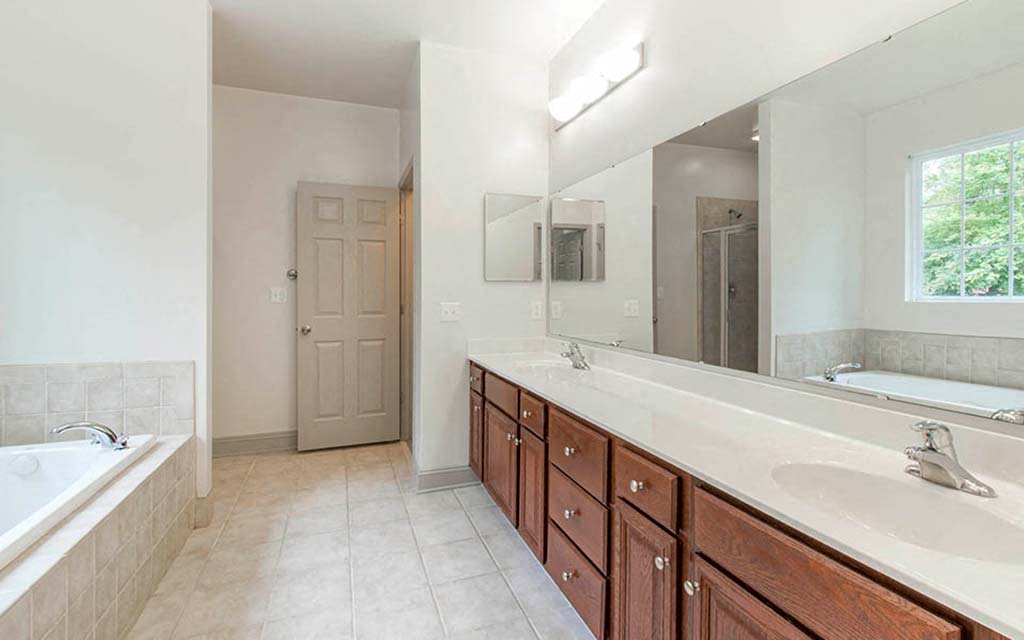 a bathroom with two sinks and a large mirror