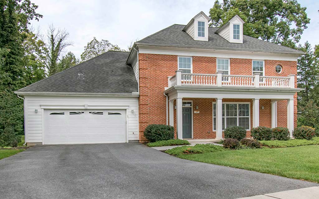 a large brick house with a white garage door