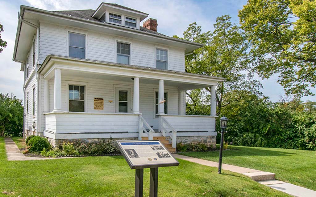 an old with a sign in front of it