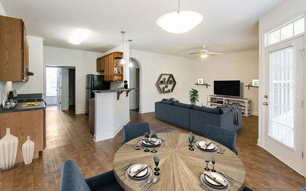 an open living room and kitchen with a table and chairs