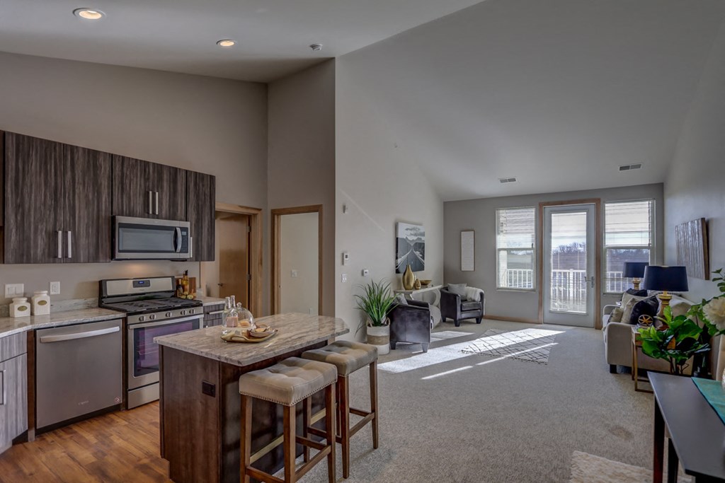 an open kitchen and living room with a view of a living room