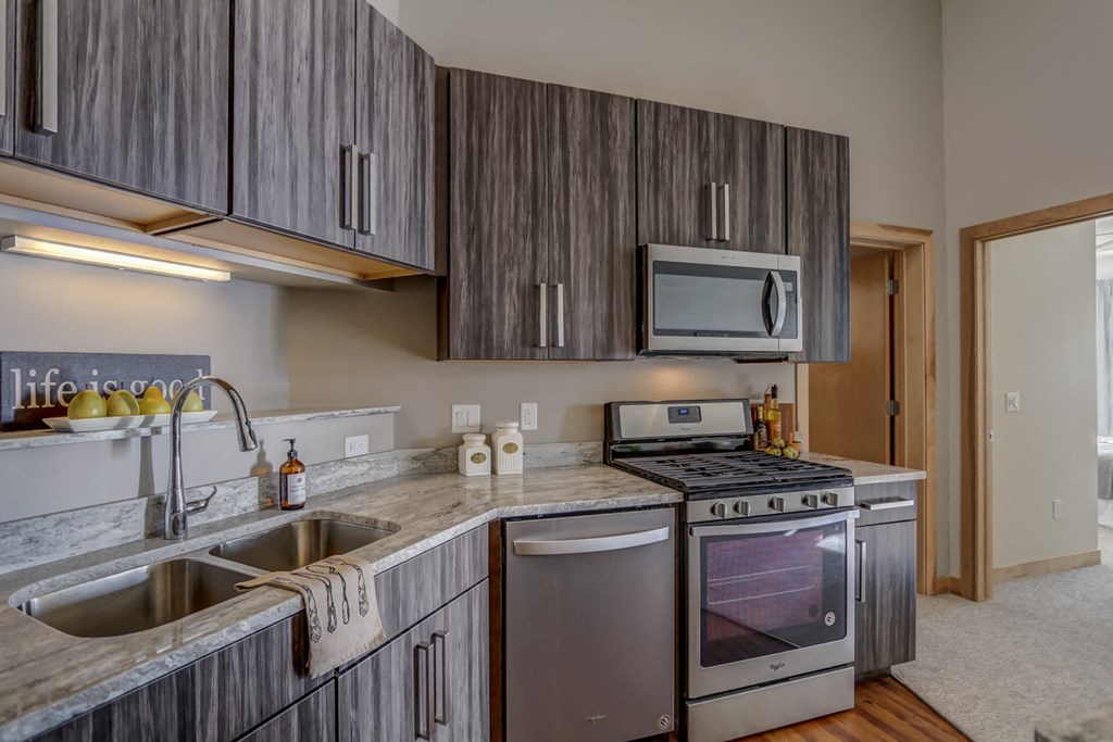 a kitchen with stainless steel appliances and a counter top