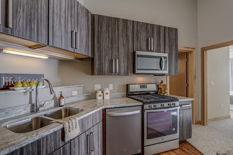 a kitchen with stainless steel appliances and a counter top