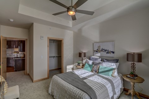 a bedroom with a large bed and a ceiling fan
