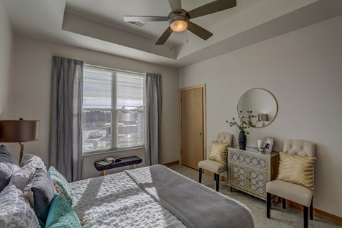 a bedroom with a large bed and a ceiling fan
