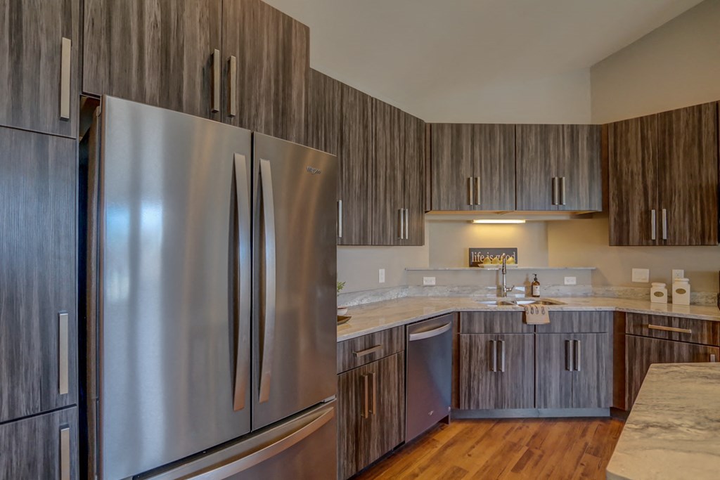 a kitchen with stainless steel appliances and wooden cabinets