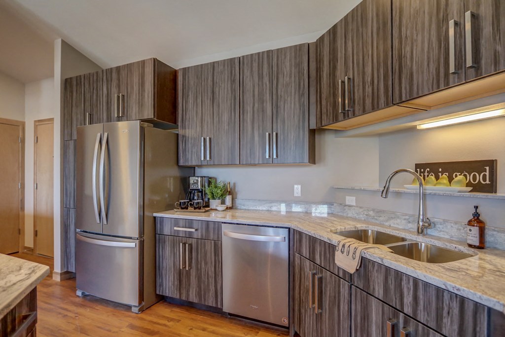 a kitchen with wooden cabinets and stainless steel appliances
