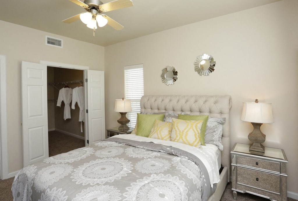 a bedroom with a bed and a ceiling fan