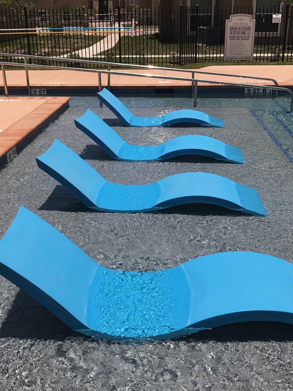 a group of blue benches in a park