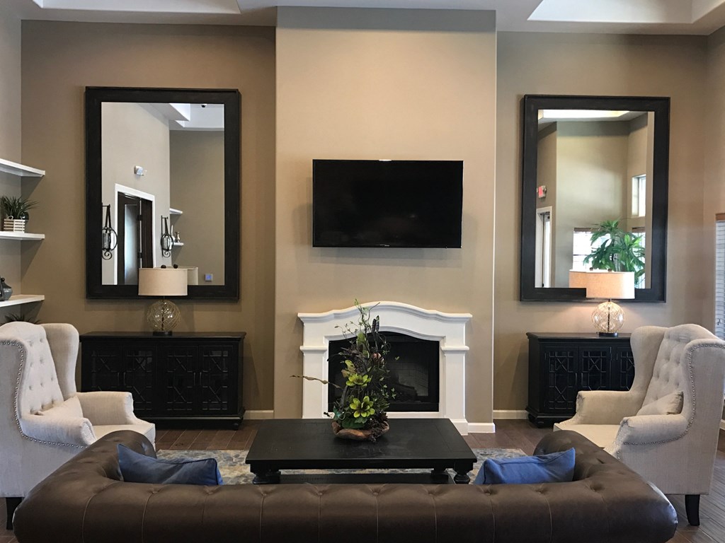 a living room with a fireplace and a tv on the wall