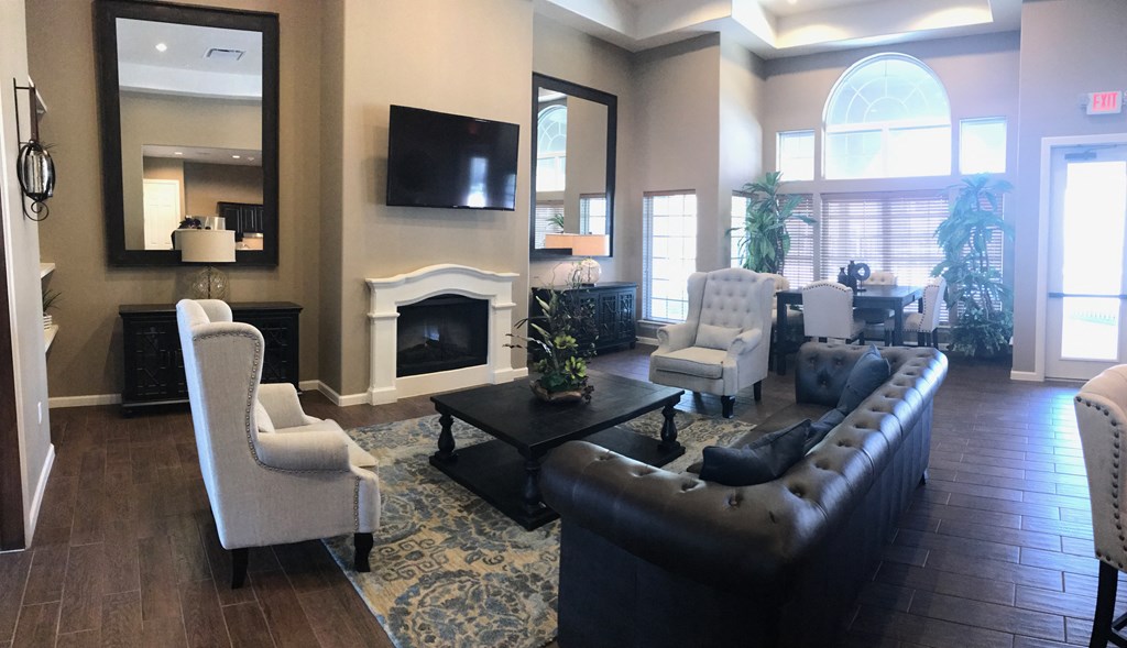 a living room with couches and chairs and a television