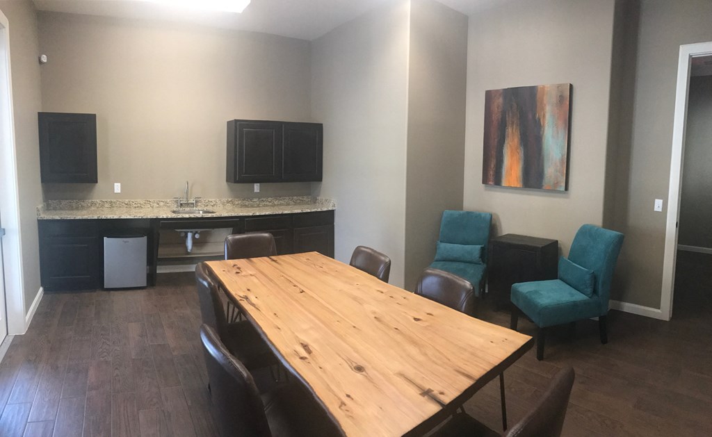 a conference room with a wooden table and chairs