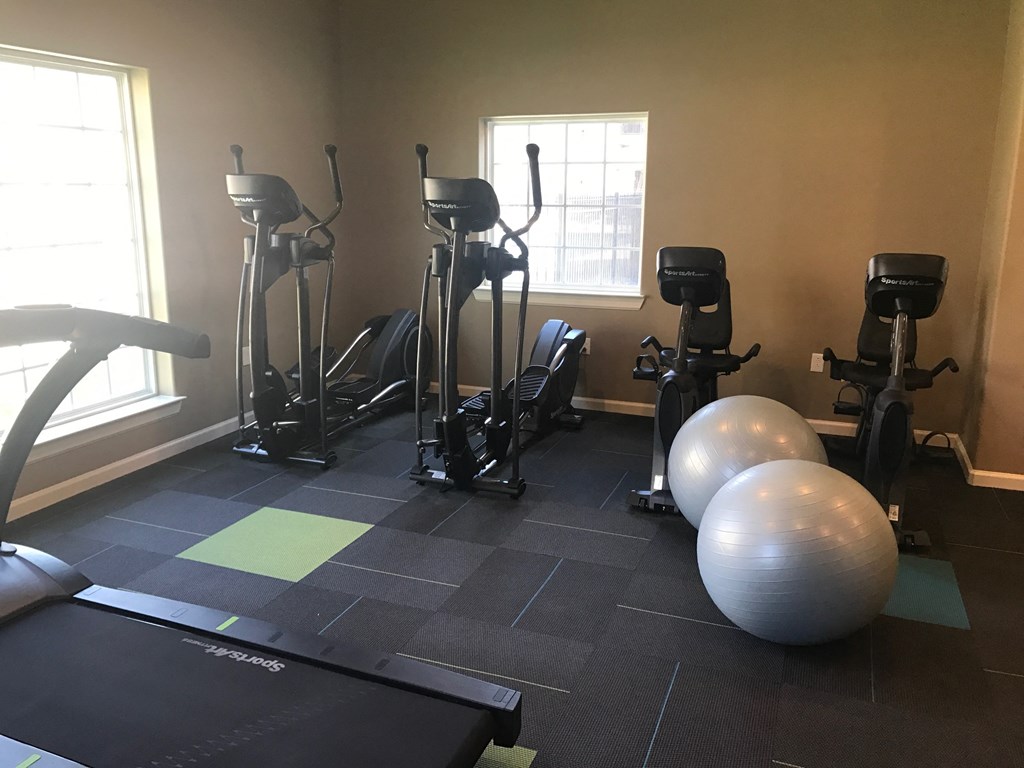 a gym with exercise equipment and exercise balls