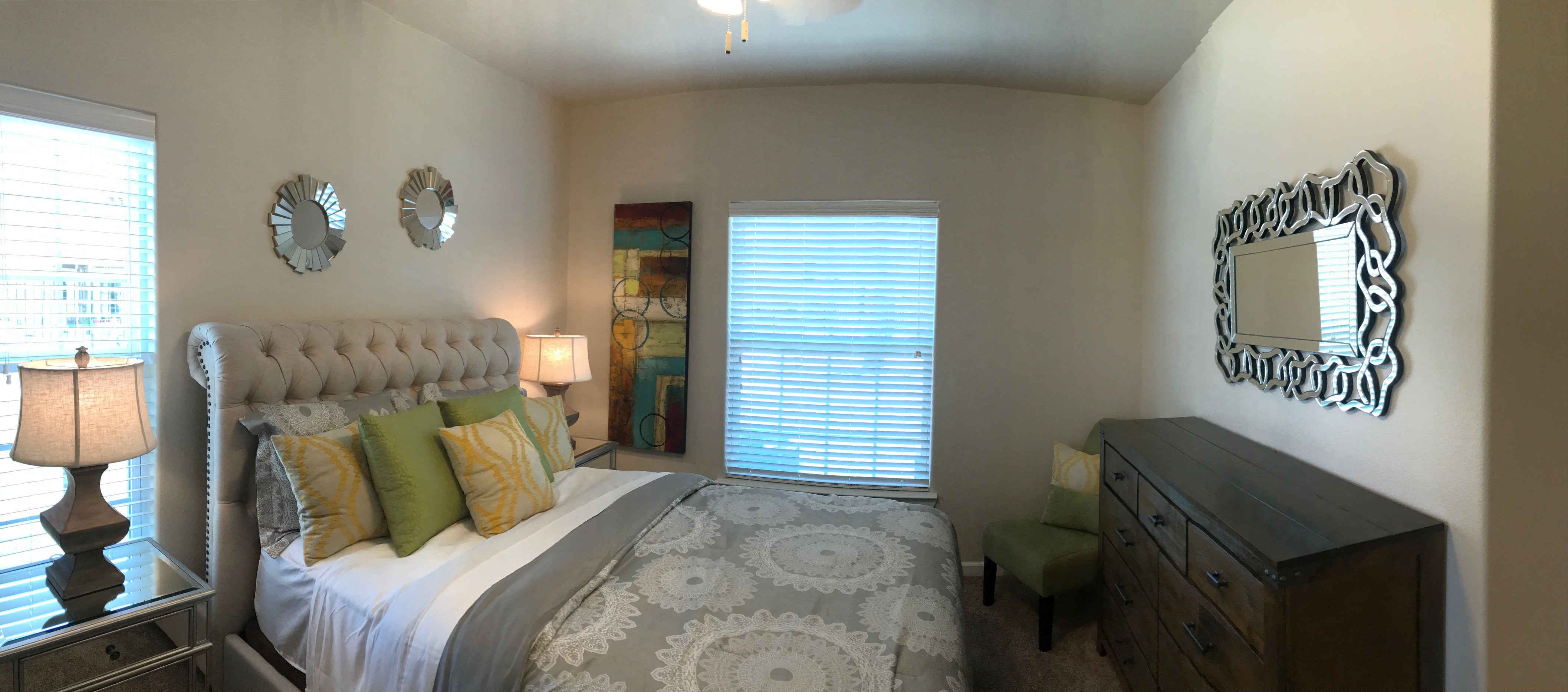 a bedroom with a bed and a dresser and a window