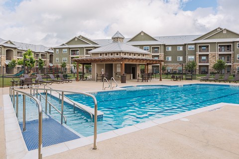 a swimming pool with a building in the background