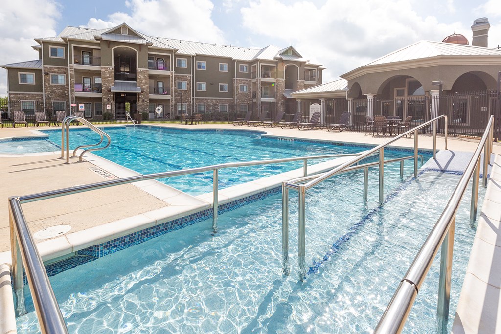 a swimming pool with a building in the background