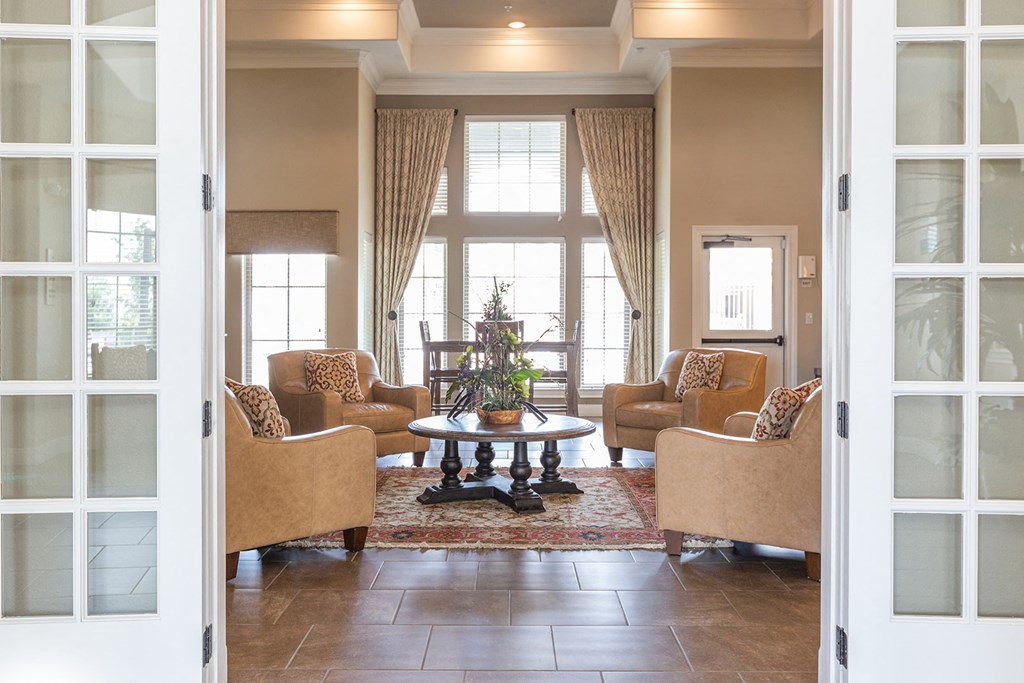 a living room with couches and chairs and a table