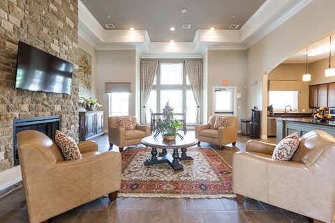a living room with couches and chairs and a fireplace