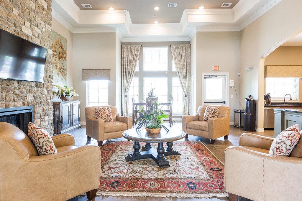 a living room with couches and chairs and a fireplace
