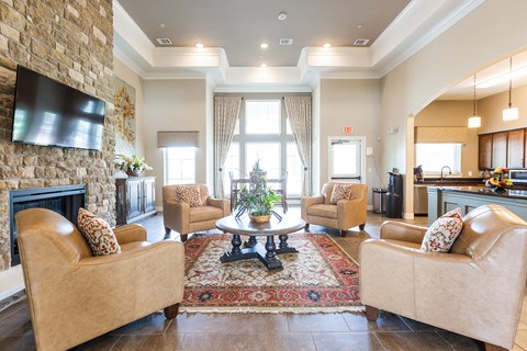 a living room with couches and chairs and a fireplace
