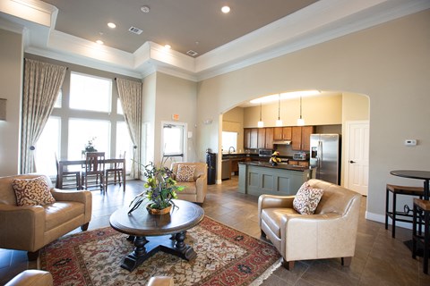 a living room and kitchen with a table and chairs