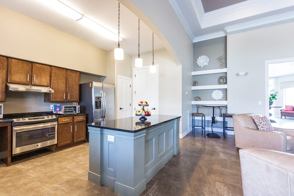 a kitchen with a blue island and a living room