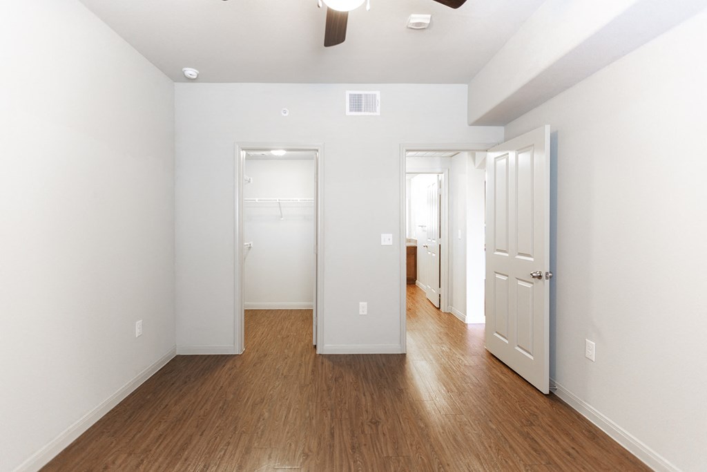 a renovated living room with white walls and wood floors