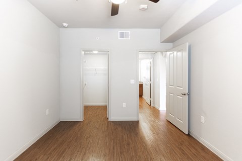 a renovated living room with white walls and wood floors