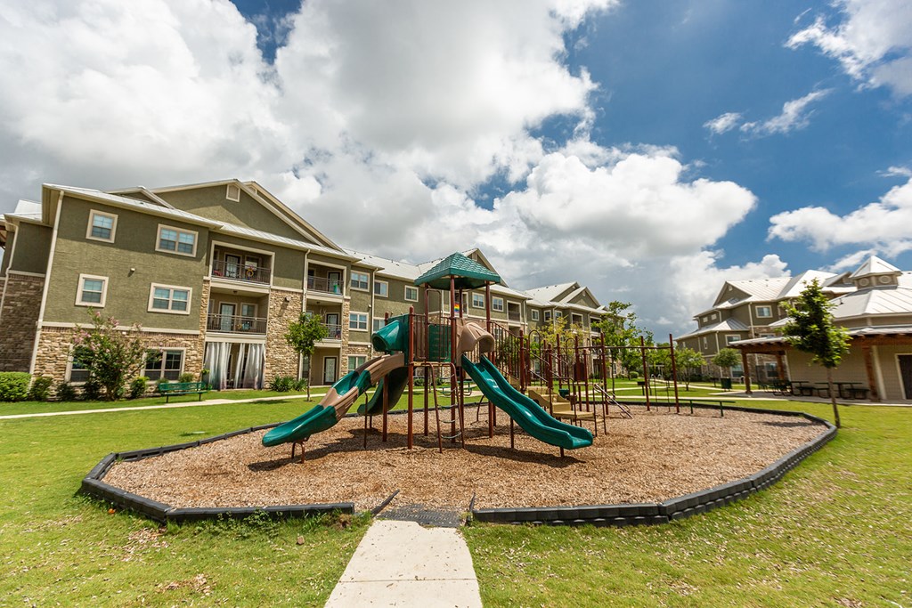 the preserve at ballantyne commons playground with slides in front of an apartment building