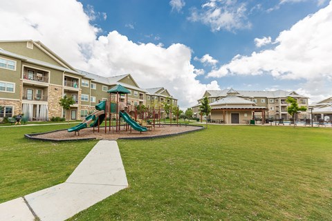 the preserve at ballantyne commons park with playground and buildings