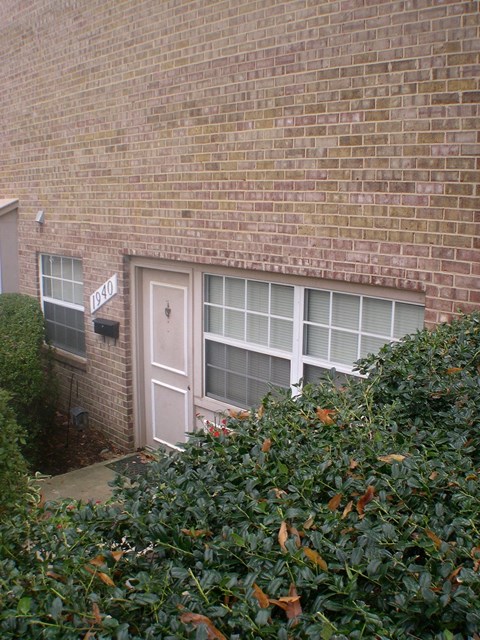 a brick building with a white door and windows